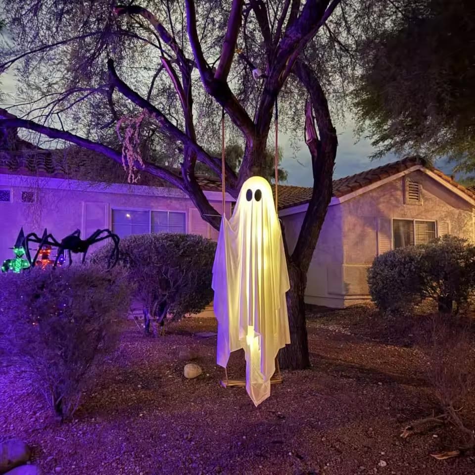 Glowing ghost sitting on a wooden swing hanging from a porch